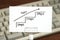 Handwriting stairs heading upwards with arrow on paper. Business success concept and growth idea.