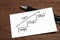 Handwriting stairs heading upwards with arrow on paper. Business success concept and growth idea.