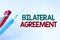 Handwriting text Bilateral Agreement. Business overview Legal obligations to nonbinding agreements of principle