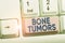 Handwriting text Bone Tumors. Concept meaning can be either benign or malignant growths found in the bone White pc
