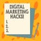 Handwriting text Digital Marketing Hacks. Concept meaning Using skills or system hacking to generate leads Stack of