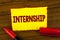 Handwriting text Internship. Concept meaning Student or trainee who works in a company to obtain experience written on Yellow Stic