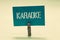 Handwriting text Karaoke. Concept meaning Entertainment singing along instrumental music played by a machine Clothespin holding tu