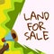 Handwriting text Land For Sale. Internet Concept Real Estate Lot Selling Developers Realtors Investment Man Holding