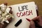 Handwriting text Life Coach. Concept meaning Mentoring Guiding Career Guidance Encourage Trainer Mentor written by Man on Notebook
