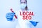 Handwriting text Local Seo. Business approach helps businesses promote products and services to local customers Studying