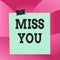 Handwriting text Miss You. Concept meaning Feeling sad because you are not here anymore loving message Paper lines binder clip