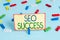 Handwriting text Seo Success. Concept meaning accomplishment or achievement of increasing traffic to a website Colored clothespin
