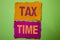 Handwriting text Tax Time. Concept meaning Taxation Deadline Finance Pay Accounting Payment Income Revenue written on Tear Papers