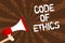 Handwriting text writing Code Of Ethics. Concept meaning Moral Rules Ethical Integrity Honesty Good procedure Man holding megaphon