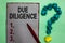 Handwriting text writing Due Diligence. Concept meaning Comprehensive Appraisal Voluntary Investigation Audit Gray paper marker cr