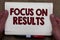 Handwriting text writing Focus On Results. Concept meaning concentrating on certain actions gains and goals Man hands holding note