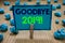 Handwriting text writing Goodbye 2019. Concept meaning New Year Eve Milestone Last Month Celebration Transition Clothespin holding