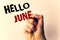 Handwriting text writing Hello June. Concept meaning Starting a new month message May is over Summer startingMan holding pen point