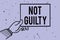 Handwriting text writing Not Guilty. Concept meaning someone is innocent didnt commit specific crime He free Man hand holding pape