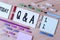 Handwriting text writing Q And A. Concept meaning defined as questions being asked and answers Colored clothespin papers empty