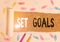 Handwriting text writing Set Goals. Concept meaning Defining or achieving something in the future based on plan.