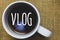 Handwriting text writing Vlog. Concept meaning Entertaining multimedia self broadcasting news reporting stories Mug coffee thought