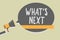 Handwriting text writing What s is Next. Concept meaning Asking whatever comes immediately after the present one Man holding megap