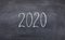 Handwriting white 2020 text on ckalk board with copy space