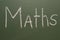 Handwritten inscription in chalk maths on a green board