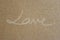 Handwritten `` LOVE `` On brown paper , Style beautifully simple.