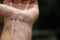 Handwritten motivational phrase on the hand `Just believe`