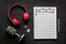 Handwritten music sheets and headphones, top view. Compose music concept