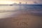 Handwritten Summer time on sandy beach at sunset