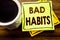 Handwritten text showing Bad Habits. Business concept for Improvement Break Habitual Hebit written on sticky note paper on the woo