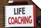 Handwritten text showing Life Coaching. Business concept writing for Personal Coach Help Written on notepad note paper, wooden bac
