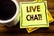Handwritten text showing Live Chat . Business concept for Communication Livechat written on sticky note paper on the wooden wood b