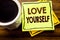 Handwritten text showing Love Yourself. Business concept for Positive Slogan For You written on sticky note paper on the wooden wo