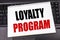 Handwritten text showing Loyalty Program. Business concept writing for Marketing Concept written on notepad note paper on the blac