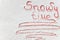 Handwritten text `Snowy time` on the snow
