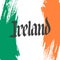 Handwritten word Ireland and brush strokes in colors of the irish national flag.