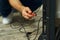 Handy home repair. Close up shot of hand of a repairman using a screwdriver while installing or fixing tv set indoors