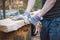 Handy woodcutter prepares larch wood for later processing. Planing wood. Working larch boards with traditional tools. Hand