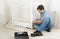 Handyman assembling wooden furniture in children`s room