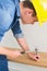 Handyman hammering nail in wooden bench