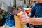 Handyman with hand saw cutting a slot in hand rail post to mount on bracket