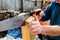 Handyman with hand saw cutting a slot in hand rail post to mount on bracket