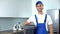 Handyman holding tools standing in kitchen, professional plumbing services