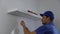 handyman installing shelf on the white wall