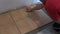 Handyman lay floor tiles at home. Closeup shot
