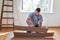 Handyman laying the parquet at renovation