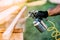 handyman, male construction worker painting wooden blocks, timber with spray gun on site