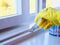 Handyman paints a window frame with white paint