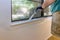 Handyman paints a window molding frame at home