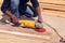 A handyman polishing wooden plank outdoor